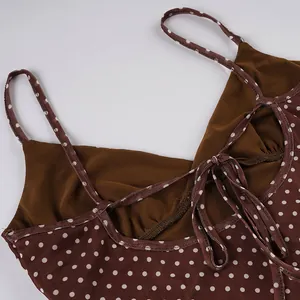 Close-up of brown polka dot sleeveless dress featuring adjustable back lace-up straps