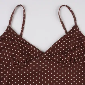 Detailed macro view of brown polka dot sleeveless camisole dress showing V-neckline and straps