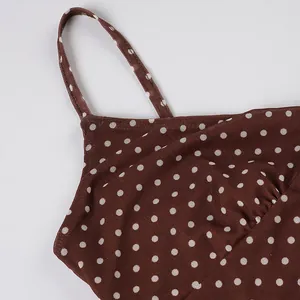 Detail of brown polka dot mesh fabric and thin strap on a women's camisole dress