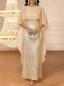 Detailed view of champagne gold sequined evening dress with sheer lace capelet