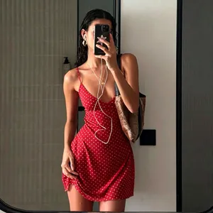 Detailed mirror selfie presentation of a chic red polka dot camisole mini dress for women