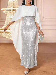 Elegant silver sequined evening gown with a flowing white chiffon cape overlay detail