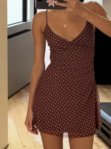 Chic brown sleeveless polka dot mini dress with delicate spaghetti straps and slim fit design