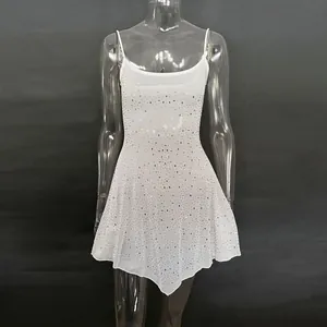 Detail view of a white semi-sheer camisole dress with shimmering rhinestone patterns.
