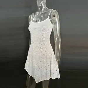 Detailed view of white rhinestone-embellished semi-sheer party dress on mannequin