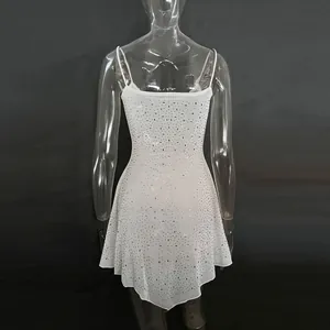 Close-up detail of white semi-sheer dress featuring shimmering rhinestone embellishments