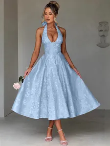 Detailed view of the light blue jacquard texture on an elegant V-neck halter maxi dress