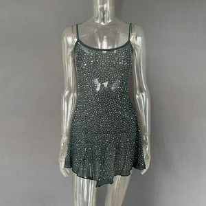 Detail of sheer dark green camisole mini dress with sparkling rhinestone embellishments.