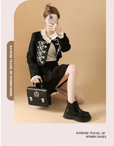 Women's British style black platform Chelsea boots shown in a full fashionable outfit
