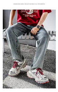 Stylishly designed men's breathable chunky sneakers worn with denim jeans on a bench