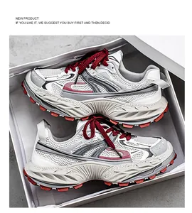 Top view of stylish white and red chunky sneakers presented inside a clean white shoebox