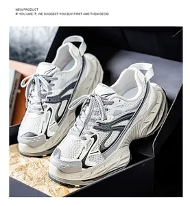 Close-up of men's white breathable chunky sneakers with thick sculptural sole