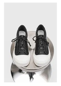 Top-down view of black and white platform sneakers showing lace-up and toe detail