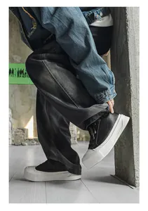 Close-up of men's low-top platform sneakers featuring a thick white sole and black upper