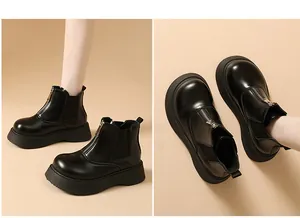 Detailed view of black platform Chelsea boots featuring front zipper and thick soles.