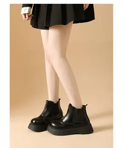 Detailed side view of elegant black platform Chelsea boots for women's autumn fashion