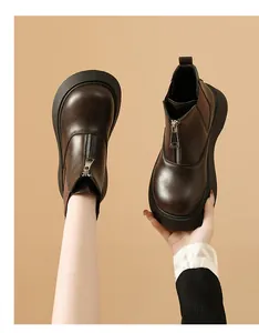 Detailed view of women's dark brown platform Chelsea boots with a front zipper and elastic sides
