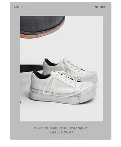 Side detail view of men's white platform sneakers with distressed grey thick sole