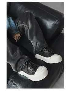 Men's low-top sneakers with chunky platform sole and black leather in lifestyle view.