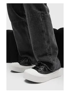 Close-up of men's low-top sneakers with chunky white platform soles and black uppers