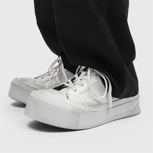 Men's avant-garde thick platform sneakers with distressed finish and low-top design.