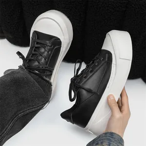 Modern men's black low-top casual sneakers featuring a chunky white platform sole design