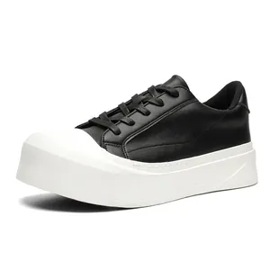 Men's designer low-top sneakers with thick white platform sole and black leather upper.