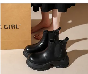 Detailed side view of black platform Chelsea boots with elastic side panels.