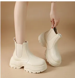Detail of women's beige platform Chelsea boots with thick lug sole