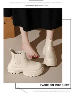 Detail view of stylish off-white platform Chelsea boots featuring thick lug soles for women.