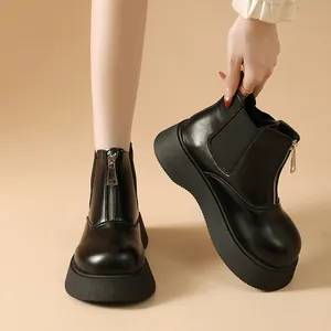 Stylish black platform Chelsea boots for women featuring a front zipper and thick rubber sole.
