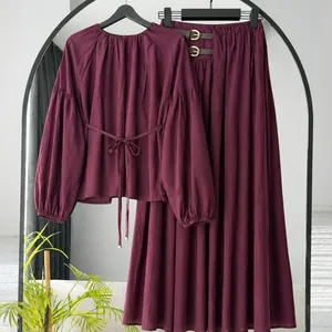 Close-up of autumn plum long-sleeved lace-up top and matching A-line skirt set