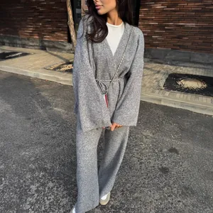 Detailed view of women's grey ribbed knit v-neck sweater and wide-leg pants set