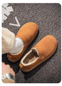 Close-up detail of men's winter slip-on boots featuring warm faux fur lining and suede upper