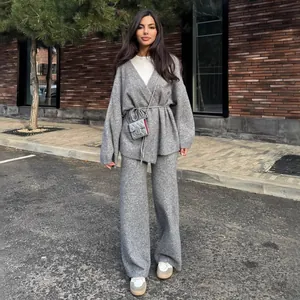 Model wearing a grey ribbed knit set featuring a V-neck tie-waist cardigan and pants