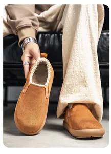 Detailed view of camel suede men's winter slip-on shoes with soft white fleece lining.