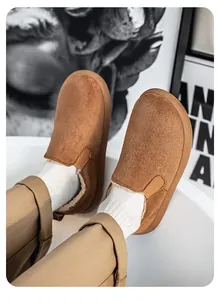 Detailed view of men's brown suede winter slip-on boots featuring cozy faux fur lining