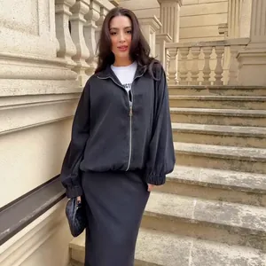 Elegant black denim two-piece clothing set with a zip-up jacket and a long mermaid skirt.