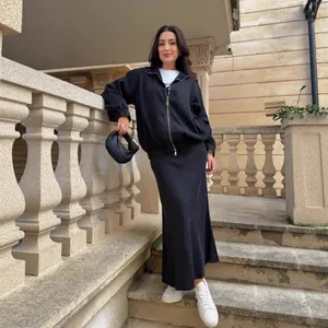 Stylish women's black denim two-piece set featuring a zip-up jacket and long skirt