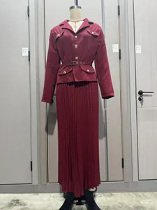 Conjunto de blazer burdeos de manga larga y falda larga plisada en un maniquí.