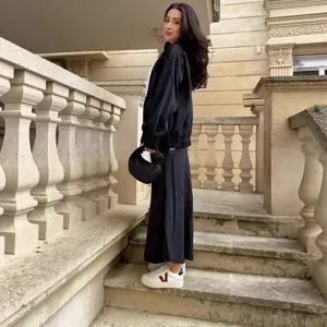 Stylish black denim two-piece set featuring a zip jacket and slim mermaid maxi skirt