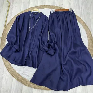 Detailed macro view of navy blue long-sleeved shirt and matching long skirt two-piece set