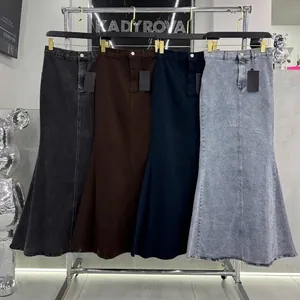 Set of high waist retro mermaid maxi skirts in four different colors hanging on a rack.