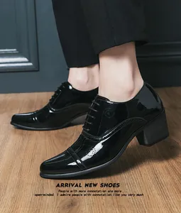 Close-up of black patent leather men's high-heeled Oxford shoes with brogue details