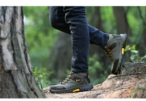 Detailed view of men's non-slip high-top hiking shoes on an outdoor forest trail path