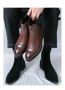 Close-up showing the sleek texture of brown leather and black Chelsea boots for men