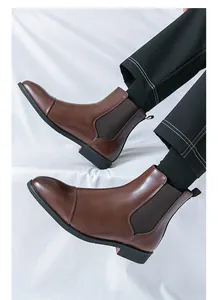 Close-up of men's brown leather Chelsea boots with pointed toe and elastic side