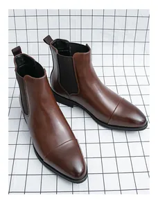 Close-up of men's brown British style leather Chelsea boots with pointed-toe design