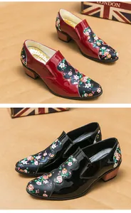 Macro detail of red and black floral patent leather shoes with stylish pointed toes.