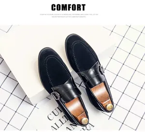 Close-up of black suede and leather monk strap loafers with stylish decorative buckles